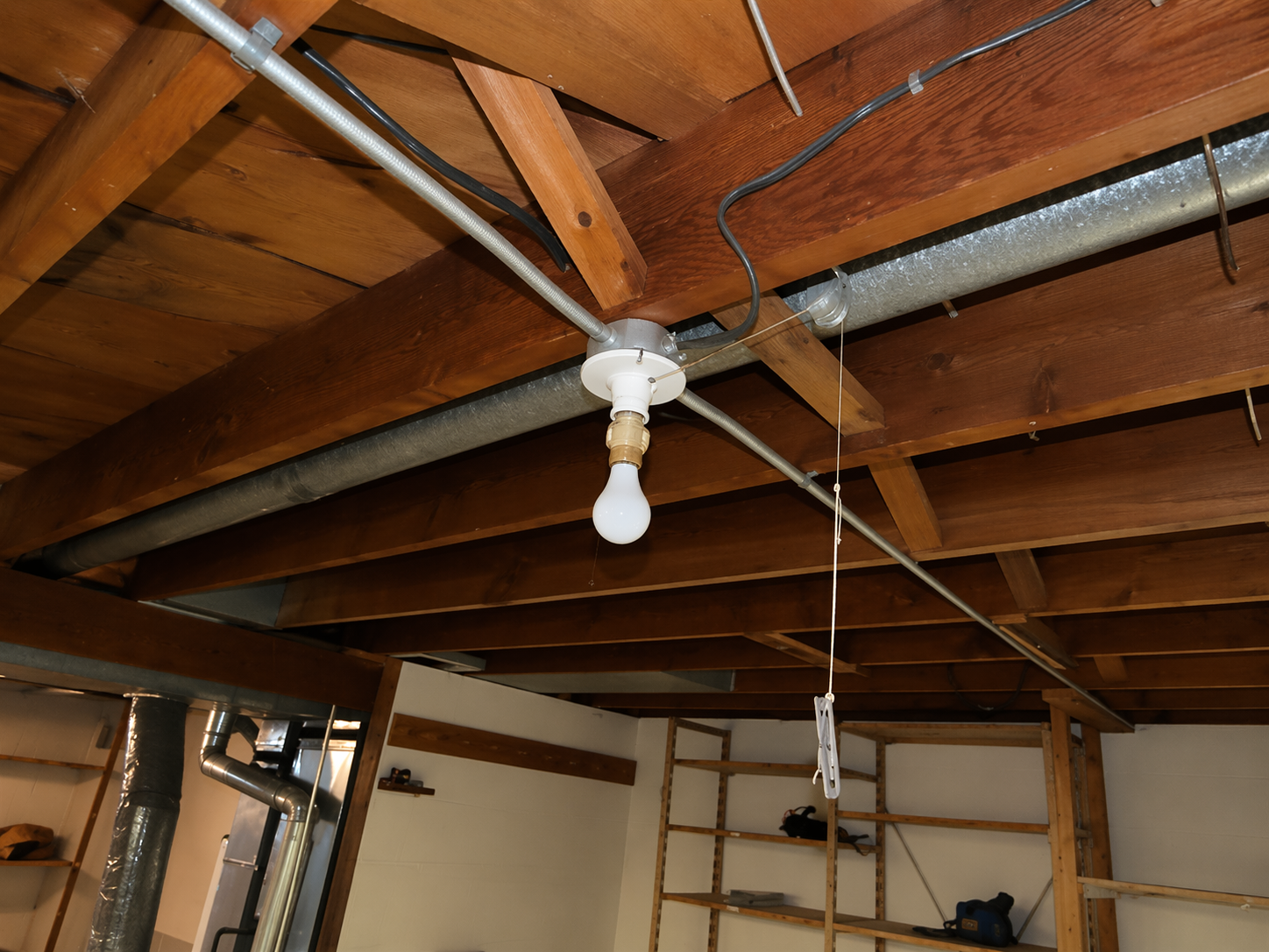 Albert Lea structural inspection — basement floor joists with electrical conduit